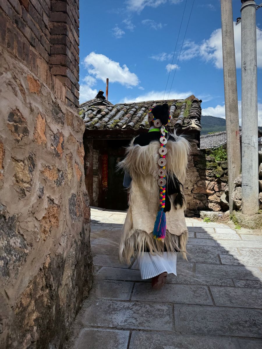 Walking through the old town wearing a traditional cape